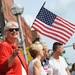 Ann Arbor native Andrea Callahan smiles as she wave an American flag at the start of the 23rd Annual Ann Arbor Jaycees Fourth of July Parade on Thursday, July 4, 2013 on South State Street in downtown Ann Arbor. Melanie Maxwell | AnnArbor.com